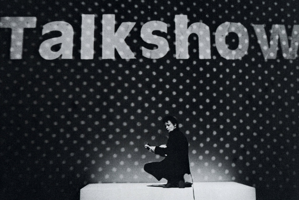 laurie anderson on stage in front of Talk Show banner